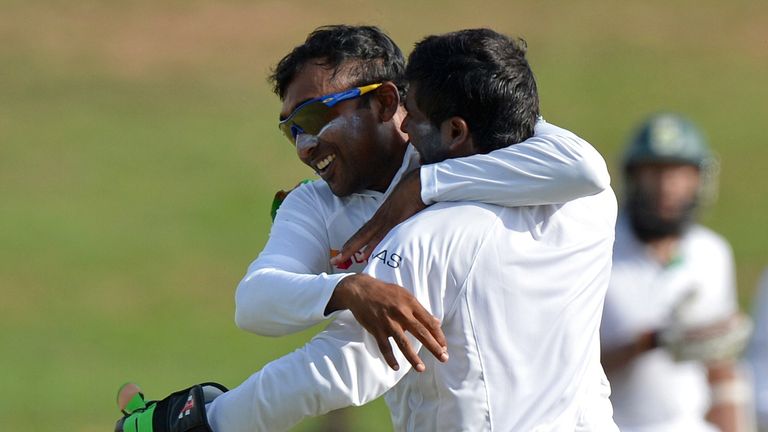 Sri Lankan cricketer Mahela Jayawardene (L) and wicketkeeper Niroshan Dickwella (R) celebrate the dismissal of South African cricketer Faf du Plessis durin