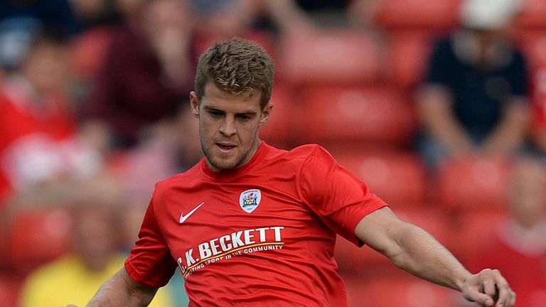 BARNSLEY, ENGLAND - JULY 12: Martin Cranie of Barnsley plays the ball during a pre-season friendly against Club Brugge at Oakwell Stadium on July 12, 2013 