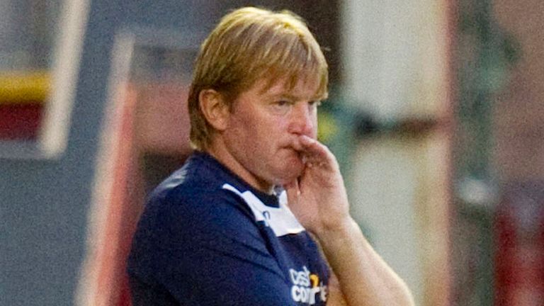 .Motherwell manager Stuart McCall watches on from the dugout