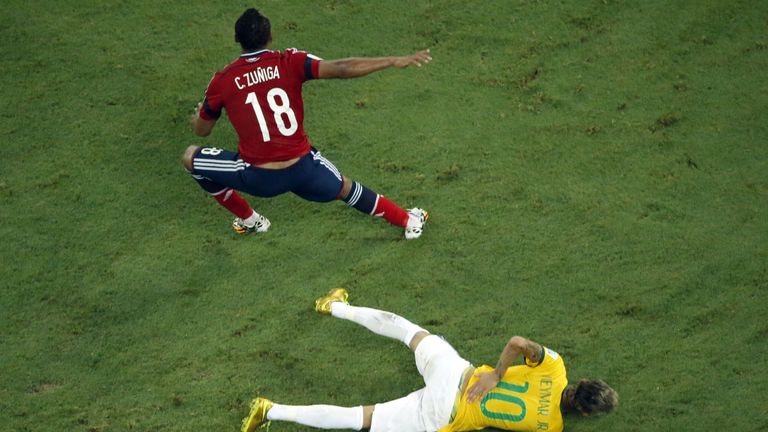 Brazil's forward Neymar reacts on the ground after being injured following a foul by Colombia's defender Juan Camilo Zuniga (L) during the quarter-final fo