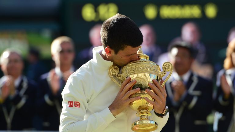 Serbia's Novak Djokovic kisses the winner's trophy