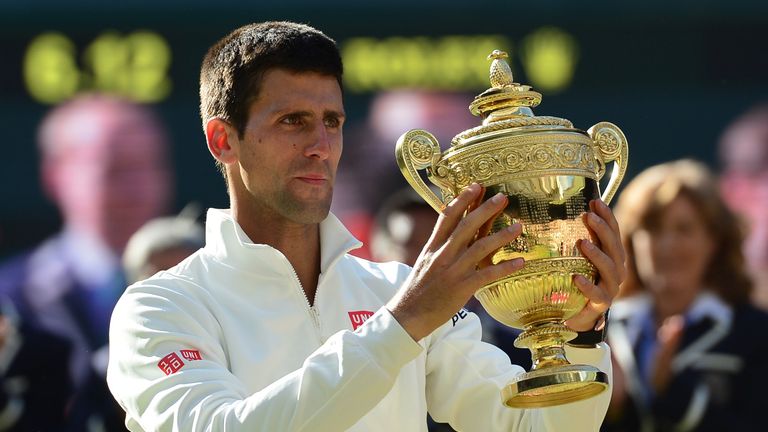 Serbia's Novak Djokovic holds the winner's trophy after beating Switzerland's Roger Federer