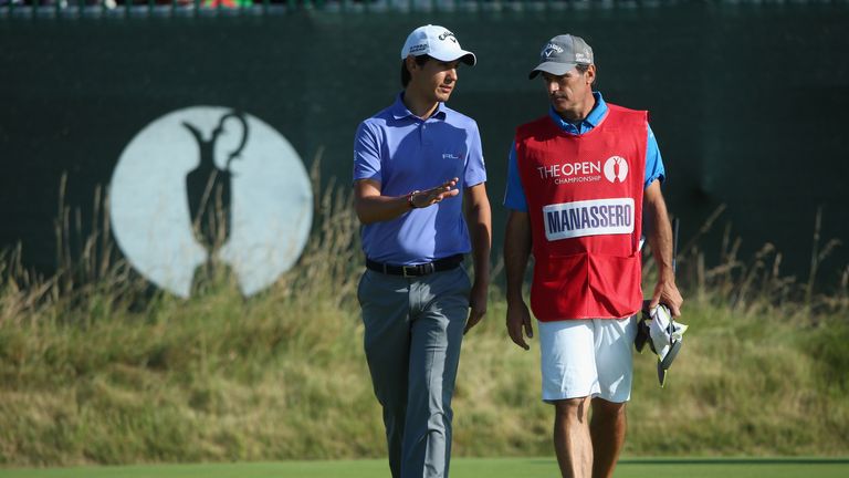 Matteo Manassero of Italy talks to his caddie and coach Alberto Binaghi during the first round of The 143rd Open Championship 
