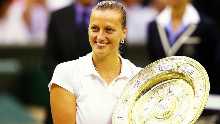 Petra Kvitova poses with the Venus Rosewater Dish trophy after her victory against Eugenie Bouchard