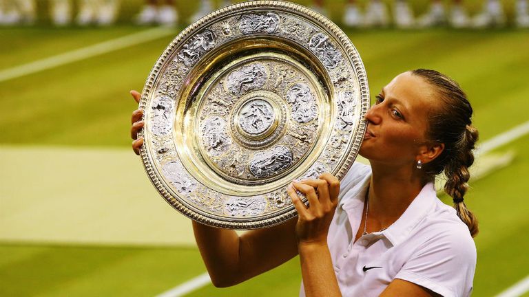 Petra Kvitova of Czech Republic poses with the Venus Rosewater Dish trophy after her victory in the Ladies' Singles final match against Eugenie Bouchard