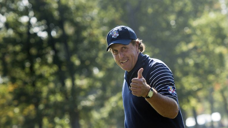 Team USA's Phil Mickelson gives a thumbs up while walking onto the 12th hole's green during the morning Four Ball Match on the second day of the 39th Ryder
