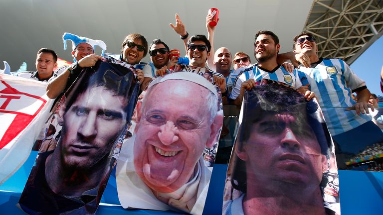Lionel Messi, The Pope and Diego Maradona. Argentina fans enjoy the atmosphere prior to the 2014 FIFA World Cup match between Argentina and Switzerland.