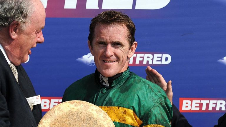 AP McCoy (centre) receives a prize after beating Martin Pipe's career total of 4,191 winners during Betfred and The Journal Ladies Day at Market Rasen Race
