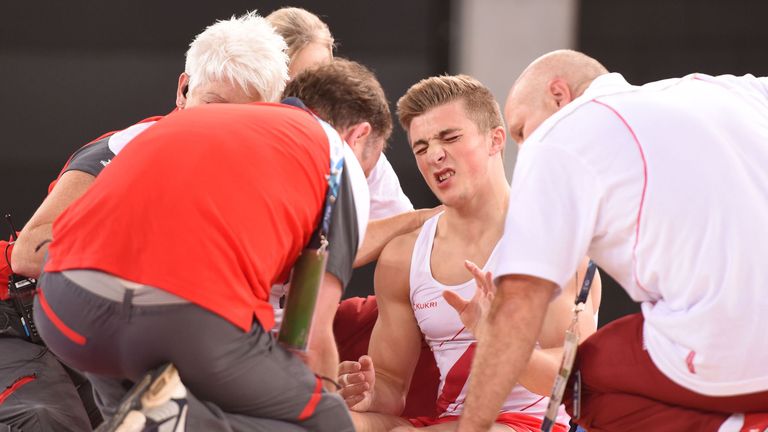 England's Sam Oldham is attended to by medical staff after suffering an injury