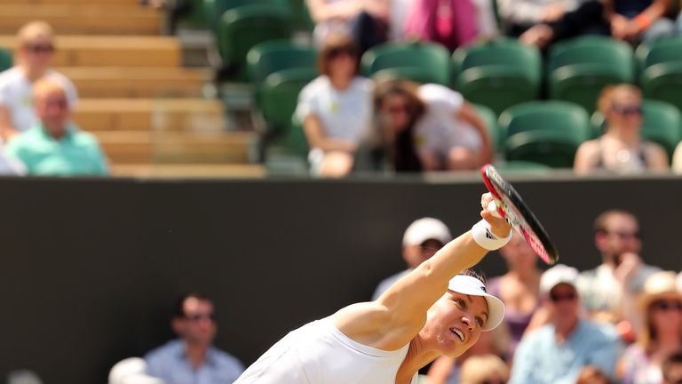 Romania's Simona Halep serves to Kazakhstan's Zarina Diyas during their women's singles fourth round match on day eight of the 2014 Wimbledon Championships