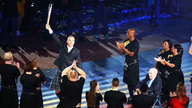 Sir Chris Hoy delivers the Queen's Baton at the opening ceremony