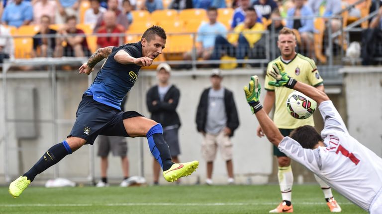 Manchester City's Stevan Jovetic scores past AC Milan goalkeeper Michael Agazzi during a Champions Cup match at Heinz Field in Pittsburgh on July 27, 2014.