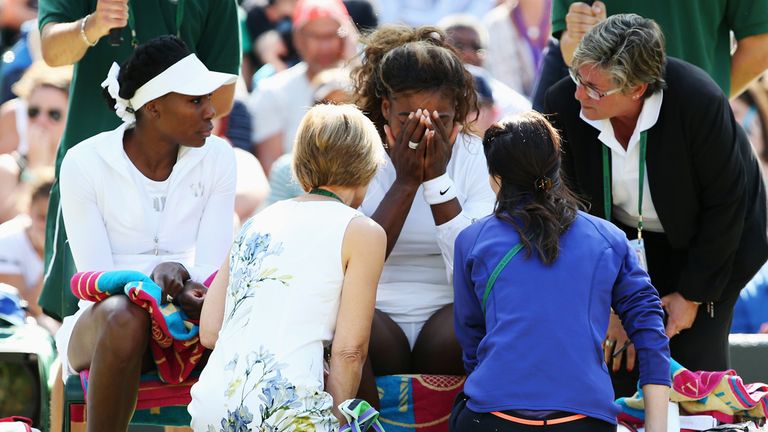 Serena Williams of the United States recieves treatment during the warm up before the Ladies Doubles second round match at Wimbledon 2014