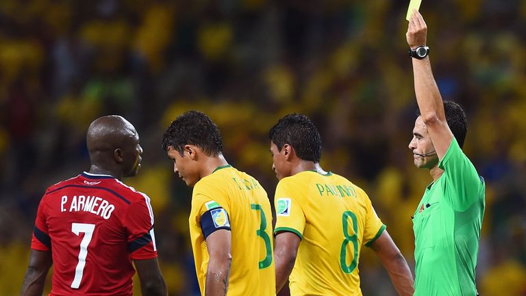 Referee Carlos Velasco Carballo shows Thiago Silva a yellow card during Friday's quarter-final against Colombia