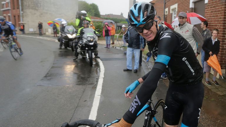 Christopher Froome grimaces as he gets up after a third consecutive crash in two days prior to abandoning the race during stage five of the Tour de France