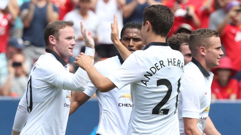 Wayne Rooney celebrates scoring Manchester United's third goal against Roma