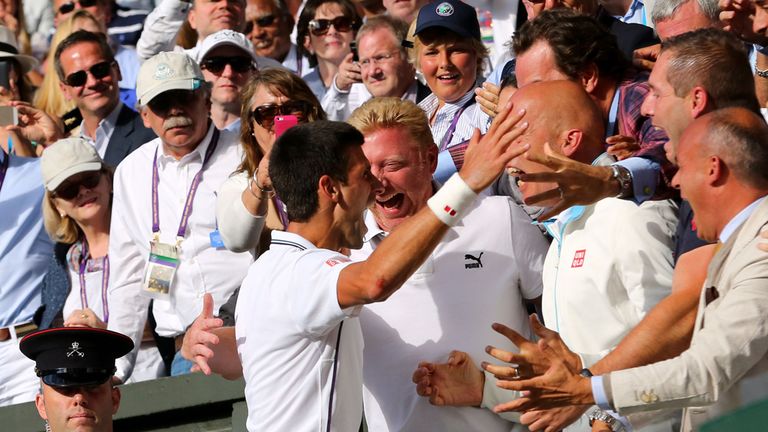 Serbia's Novak Djokovic goes to his players box after beating Switzerland's Roger Federer in the Mens singles final during day fourteen of the Wimbledon Ch