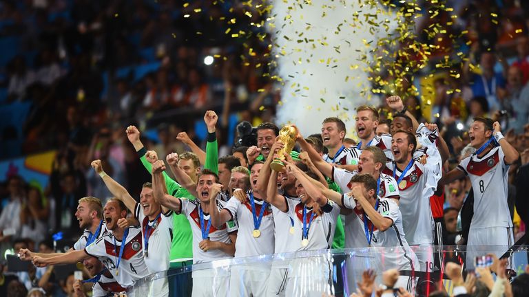 Philipp Lahm of Germany lifts the World Cup trophy with team-mates after defeating Argentina 1-0 in extra time
