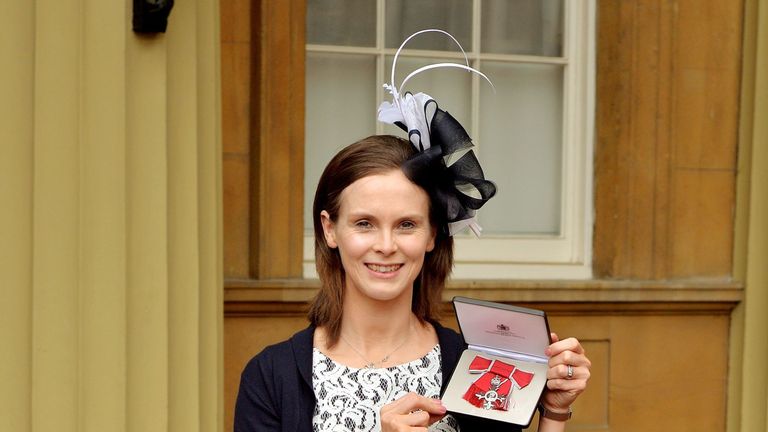 LONDON, ENGLAND - MAY 01:  Karen Atkinson poses with her MBE for services to netball after she was awarded it by Princess Anne, Princess Royal at an Invest