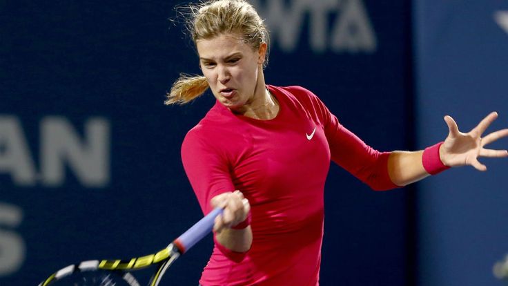 Eugenie Bouchard of Canada returns a shot to Samantha Stosur of Australia during the Connecticut Open at the Connecticut Tennis Center