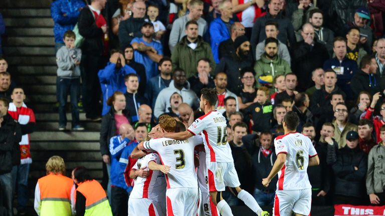 Will Grigg: Mobbed by team-mates after second goal