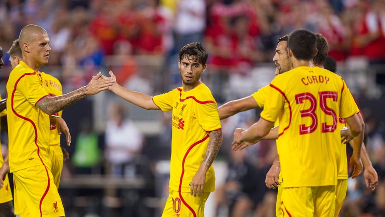 Suso of Liverpool is congratulated by teammates after scoring in the 2-0 win over AC Milan