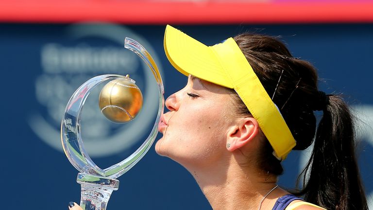 Agnieszka Radwanska of Poland kisses the trophy after defeating Venus Williams of the USA in the final of the Rogers Cup