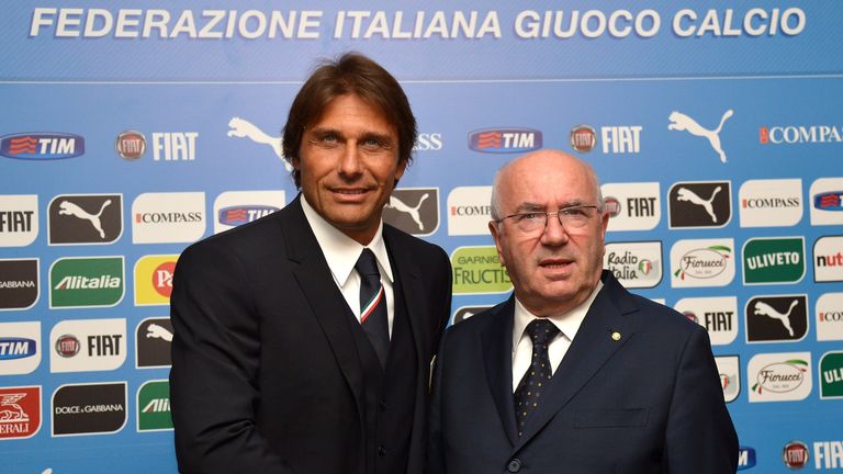New Italian Football Federation (FIGC) president Carlo Tavecchio (R) shakes hands with Italy's national football team new coach Antonio Conte