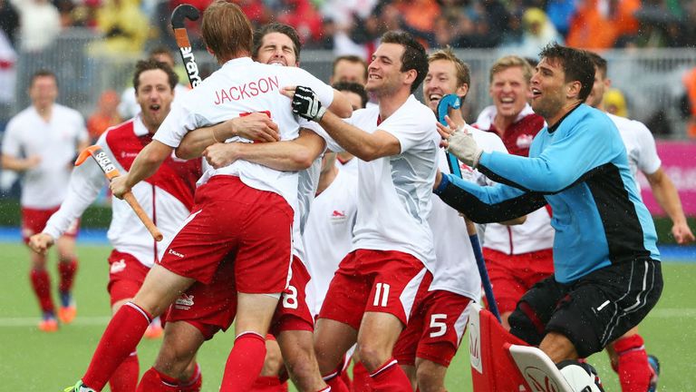 Ashley Jackson of England is congratulated by team-mates after his decisive penalty stroke to win bronze against New Zealand