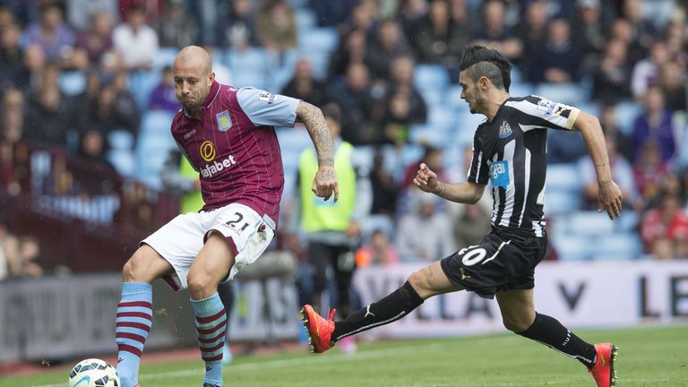Alan Hutton (L) of Aston Villa is challenged by Remy Cabella of Newcastle United during the Barclays Premier League match at Villa Park