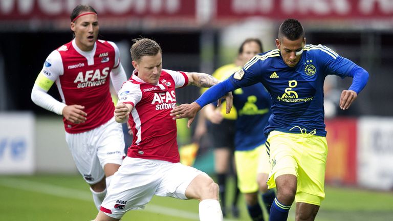 Ajax forward Ricardo Kishna vies for the ball with AZ Alkmaar defender Mattias Johansson 
