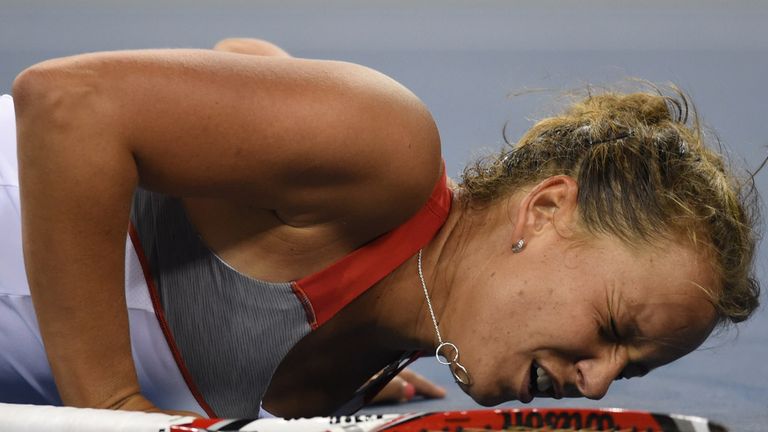 Barbora Zahlavova Strycova of the Czech Republic falls to the ground while playing against Eugenie Bouchard of Canada during their US Open 2014.