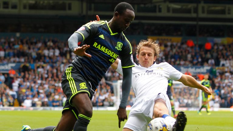 LEEDS, ENGLAND - AUGUST 16: Stephen Warnock (R) of Leeds in action with Albert Adomah of Middlesbrough during the Sky Bet Championship match between Leeds 