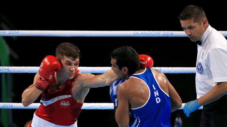 England's Scott Fitzgerald (red) in action against India's Mandeep Jangra (blue) in the Men's Welterweight (69kg) Final at the SSE Hydro, during the 2014 C