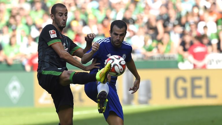Werder Bremen's Alejandro Galvez (L) and Chelsea FC's Cesc Fabregaz vie for the ball during a friendly football match on August 3, 2014 in Bremen, northern