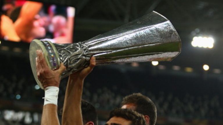 TURIN, ITALY - MAY 14: Federico Fazio  of Sevilla FC lifts the winners trophy after his sides penalty shoot out victory during the UEFA Europa League Final