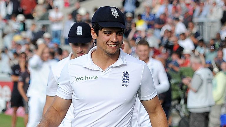 England's Alastair Cook and James Anderson leave the pitch after winning the test match against India, during the Fourth Investec Test at Emirates Old Traf