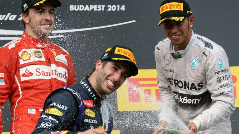Daniel Ricciardo celebrates with Fernando Alonso and Lewis Hamilton on the Hungarian GP podium