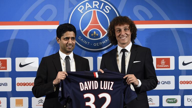 PSG newly recruited Brazilian defender David Luiz (R) holds his new jersey with PSG chairman Nasser Al-Khelaifi during his official presentation
