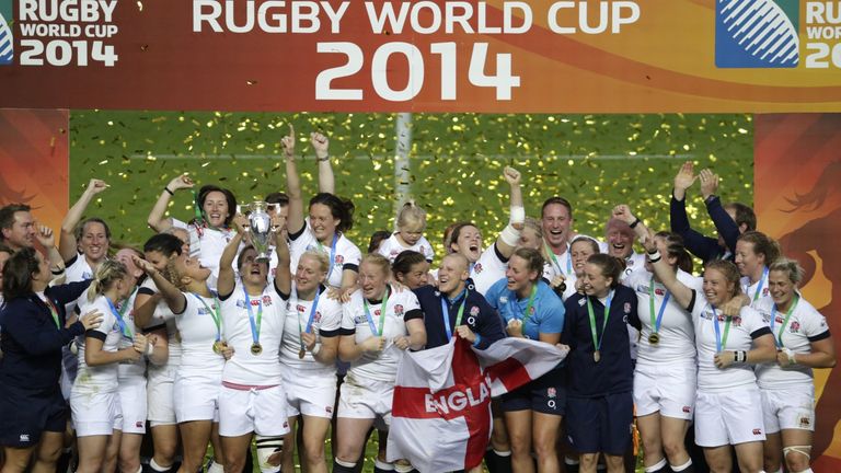 England's players celebrate with the trophy after winning the IRB Women's Rugby World Cup final match between England and Canada at the Jean Bouin Stadium 