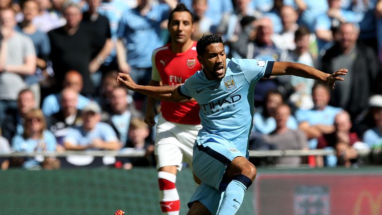 LONDON, ENGLAND - AUGUST 10:  Gael Clichy of Manchester City is tackled by Aaron Ramsey of Arsenal during the FA Community Shield match