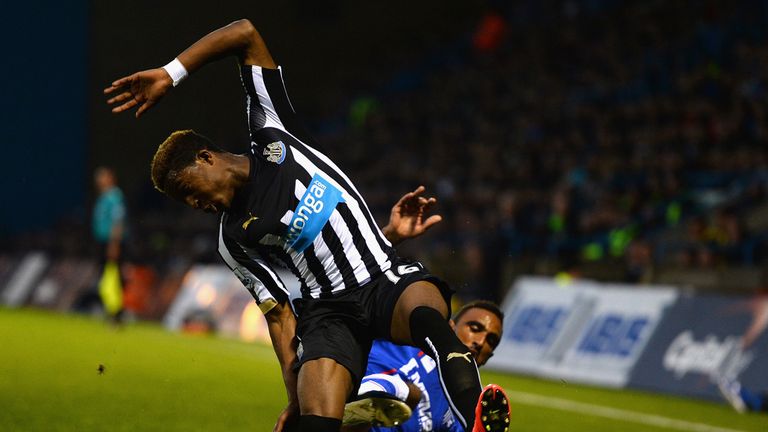 Leon Legge of Gillingham tackles Rolando Aarons of Newcastle United during the Capital One Cup second round match 
