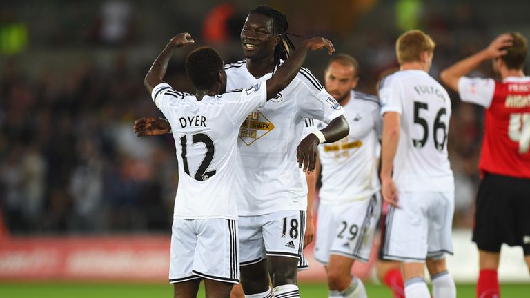 SWANSEA, WALES - AUGUST 26:  Swansea player Nathan Dyer (l) celebrates the opening goal scored by Bafetimbi Gomis during the Capital One Cup Second Round m