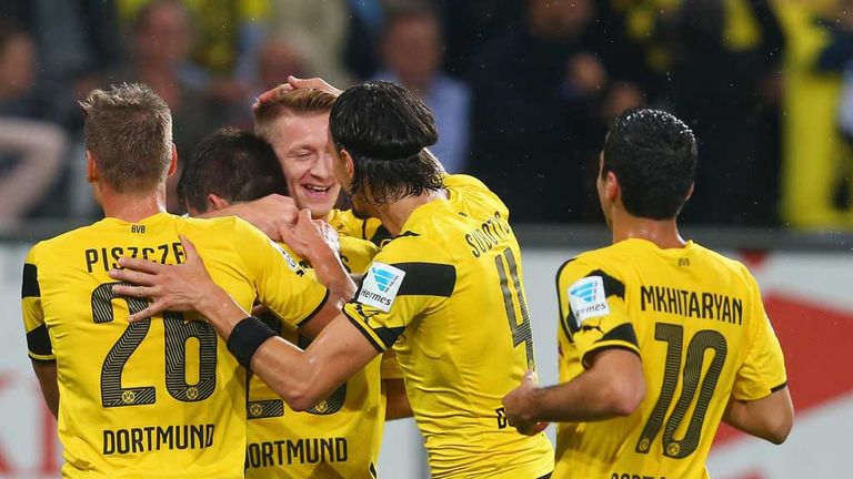 AUGSBURG, GERMANY - AUGUST 29:  Marco Reus of Borussia Dortmund congratulates Sokratis Papastathopoulos of Borussia Dortmund on scoring their 