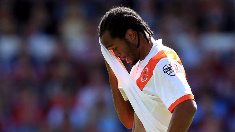 Blackpool's Nathan Delfouneso wipes sweat off his forehead during the Sky Bet Championship match at the City Ground, Nottingham.