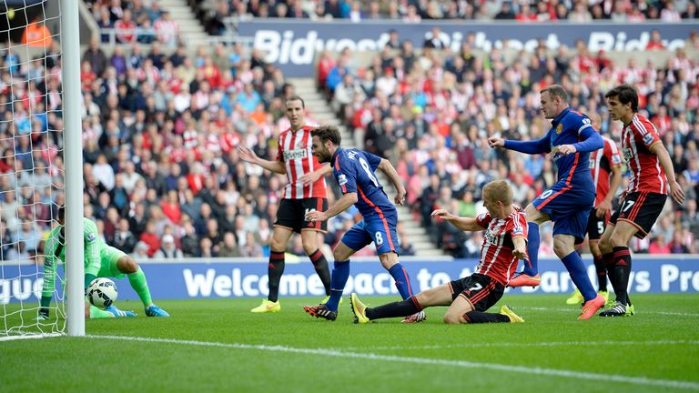 Manchester United's Juan Mata (centre) scores their first goal during the Barclays Premier League match at the Stadium of Light, Sunderland
