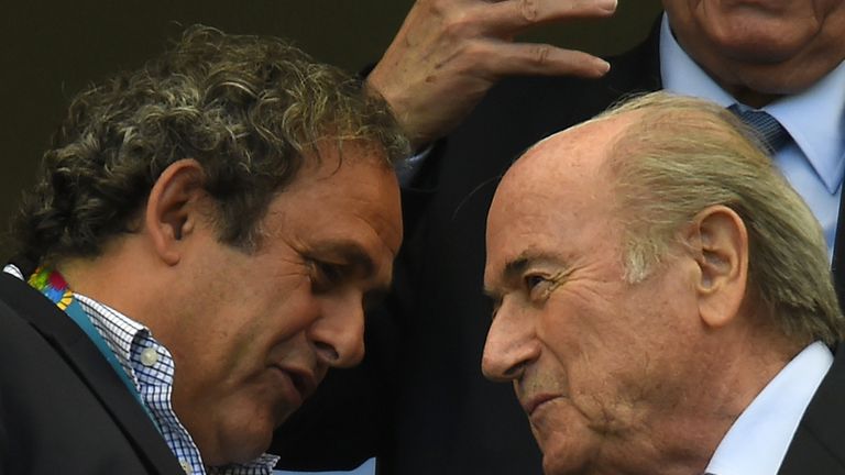 FIFA President Sepp Blatter (R) speaks with UEFA president Michel Platini during the Group G football match between Germany and Portugal