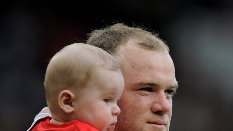 Wayne Rooney of Manchester United holds his son Kai at the end of the Barclays Premier League match