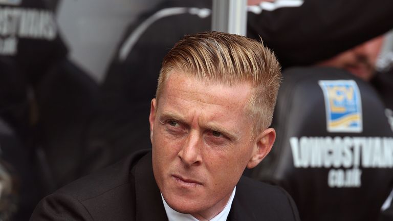 Garry Monk takes his seat for the English Premier League football match between Swansea City and Burnley at the Liberty Stadium