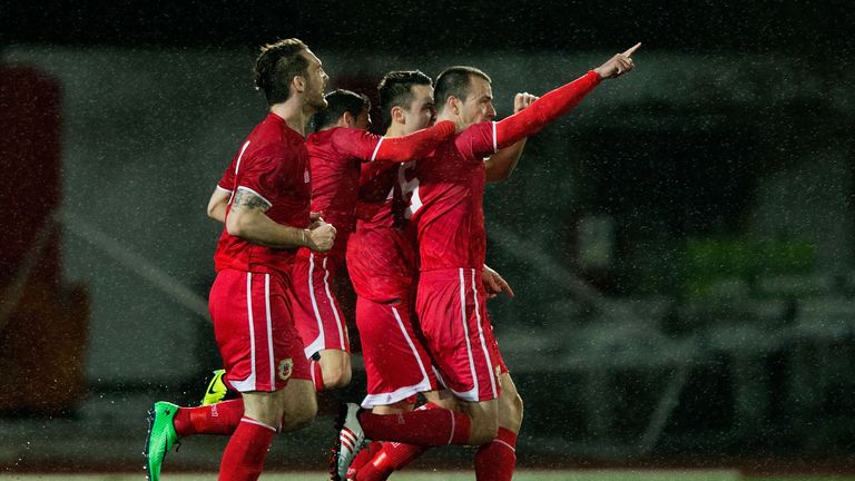 GIBRALTAR - MARCH 01: Roy Chipolina of Gibraltar celebrates scoring their opening goal with teammates during the International Friendly football match betw